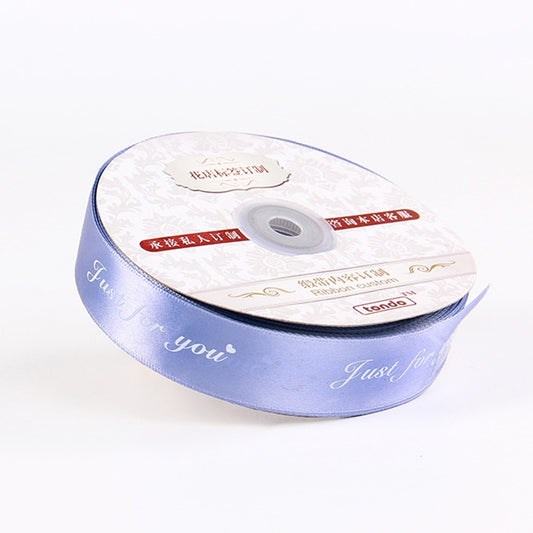 Blue satin letter ribbon roll, white print with “You” and “Just for you”