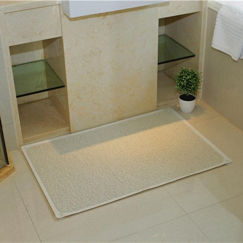 Rectangular beige-tan textured bath mat with non-slip backing for floor