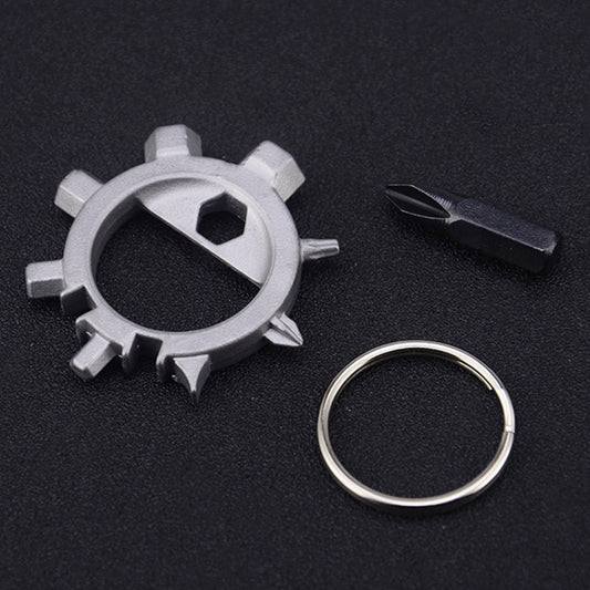 Silver gear-style keychain tool with loop ring and black screwdriver bit tool