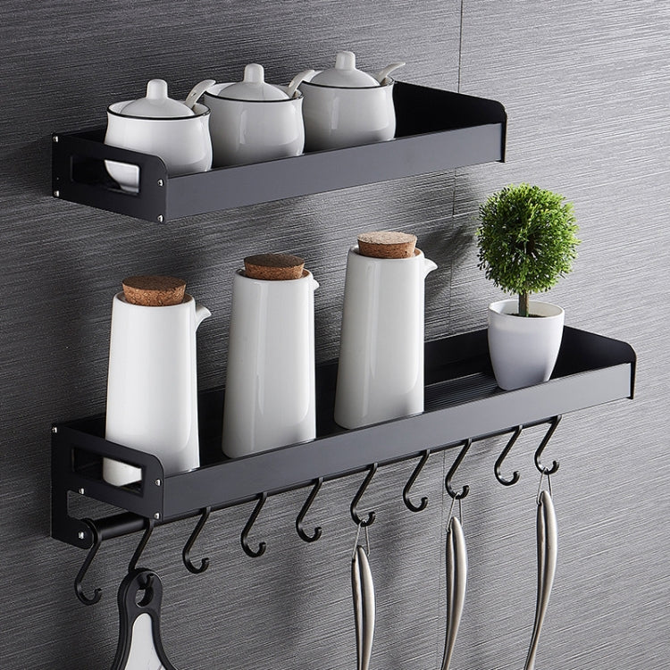Black wall hanging spice rack with two tier shelves, canisters, and six hooks