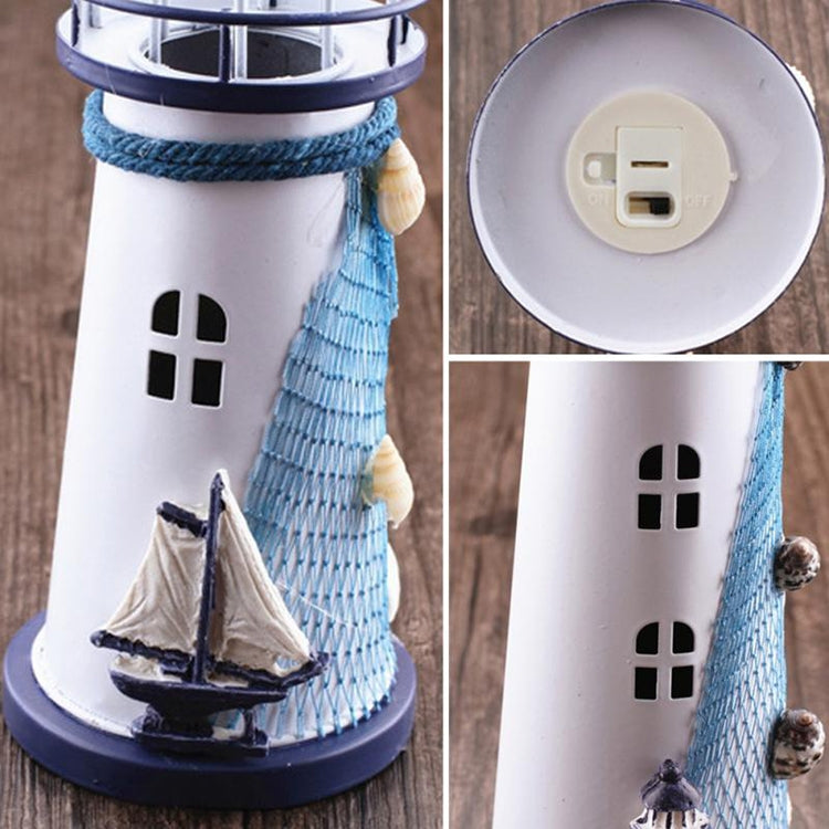 Close-up of white and blue lighthouse decor with sail detail and window cutouts