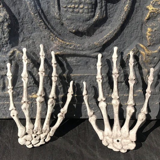 Pair of Halloween skeleton hand decoration props with open bony palms