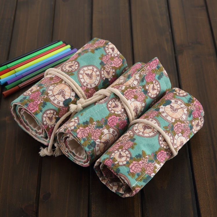 Rolled cream-and-teal pencil case with rose-clock print, drawstring ties, elastic pockets sections