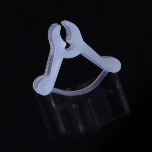 Transparent plastic plant grafting clip on a dark background