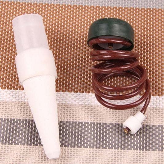 Drip irrigation emitter parts: white cone nozzle and brown coiled spring with dark cap