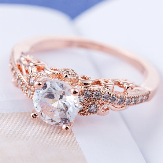 Rose gold zircon engagement ring with a round-cut center stone