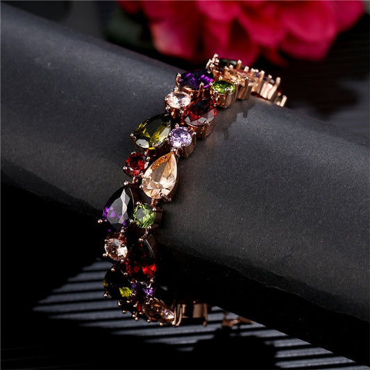 Rose gold tone multicolor zircon bead bracelet detail with oval stones and cross-link design