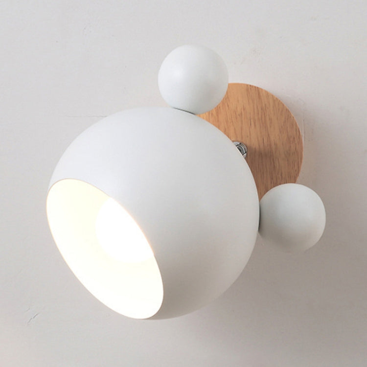 White cartoon wall lamp with globe shade and wooden circular backplate