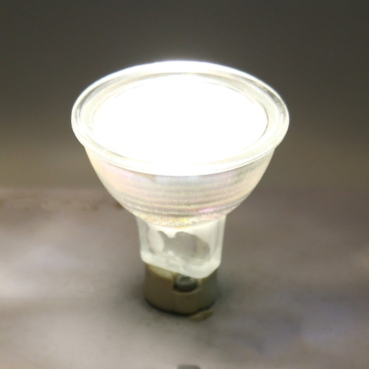 Lit MR16 LED spotlight in base, bright white light emitting through clear lens
