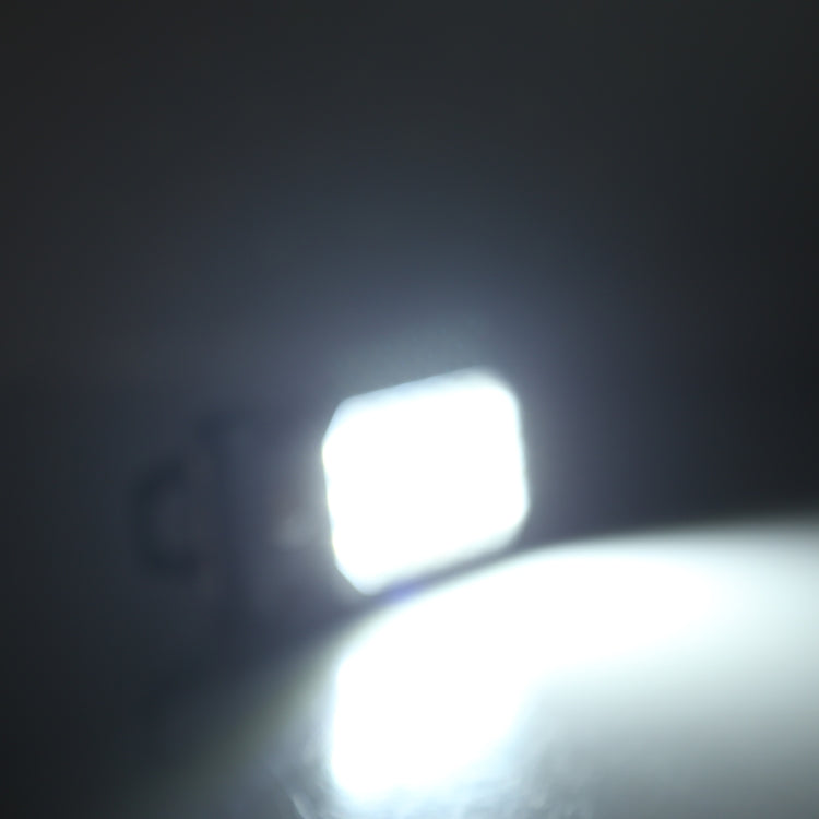 Glowing LED work light close-up with dark housing