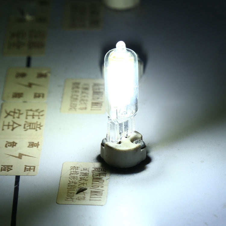 Lit glass LED bulb with clear cover, two pins, emitting bright white light