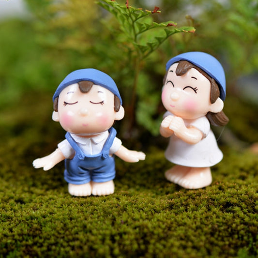 Blue hooded dollhouse garden ornament pair of PVC boy and girl figures on green moss