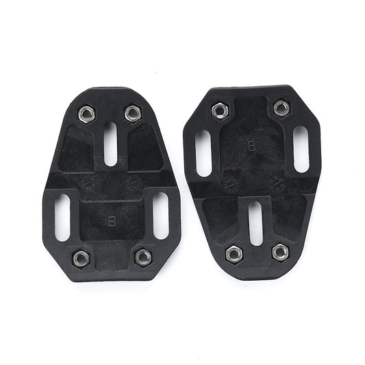 Black cleat spacer shim pair with bolt holes, shown from reverse sides