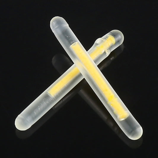 Night fishing light sticks crossed, translucent gray casings with yellow illumination