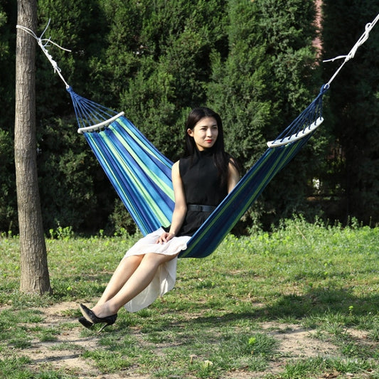 Portable single-person canvas hammock, blue and green striped fabric with wooden spreader bars