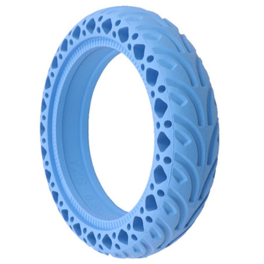 Blue solid scooter tire side view with raised tread and honeycomb-style cutouts