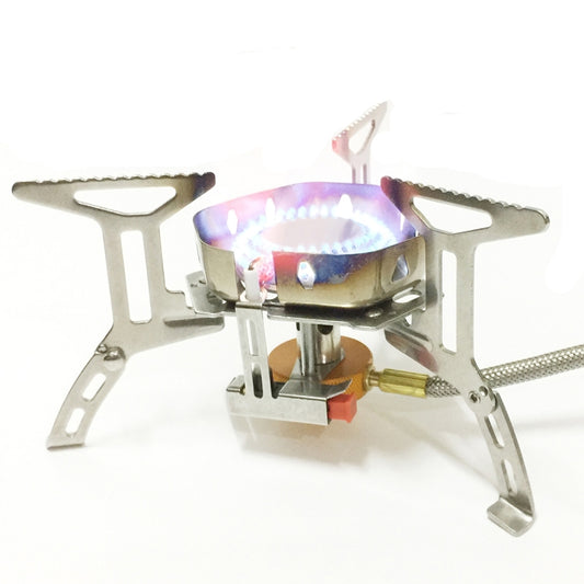 Portable stainless steel camping stove with lit burner and windproof base frame