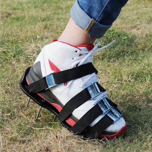Spiked garden lawn shoes with black straps, metal buckles, on white/red sneakers