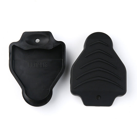 Pair of black rubber cleat protective covers with molded traction ridges and mounting holes