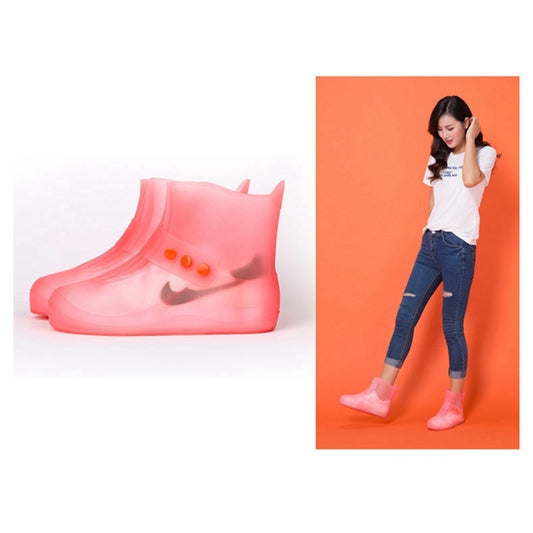Pink waterproof shoe covers with thick soles and perforated button detail on the sides