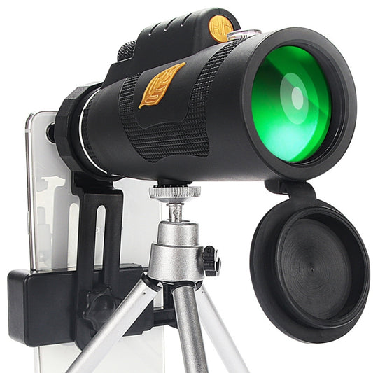 Night vision monocular telescope with green objective lens, mounted on silver tripod
