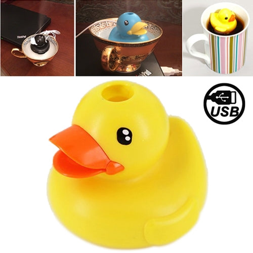 Yellow duck-shaped USB air humidifier with orange beak, sitting on a striped mug