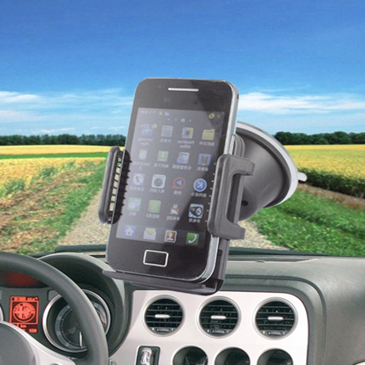 Black smartphone secured in car windshield mount holder with side grips