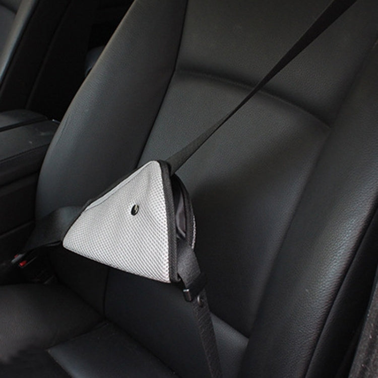 Grey mesh car seat belt adjuster pad with black trim and attached strap