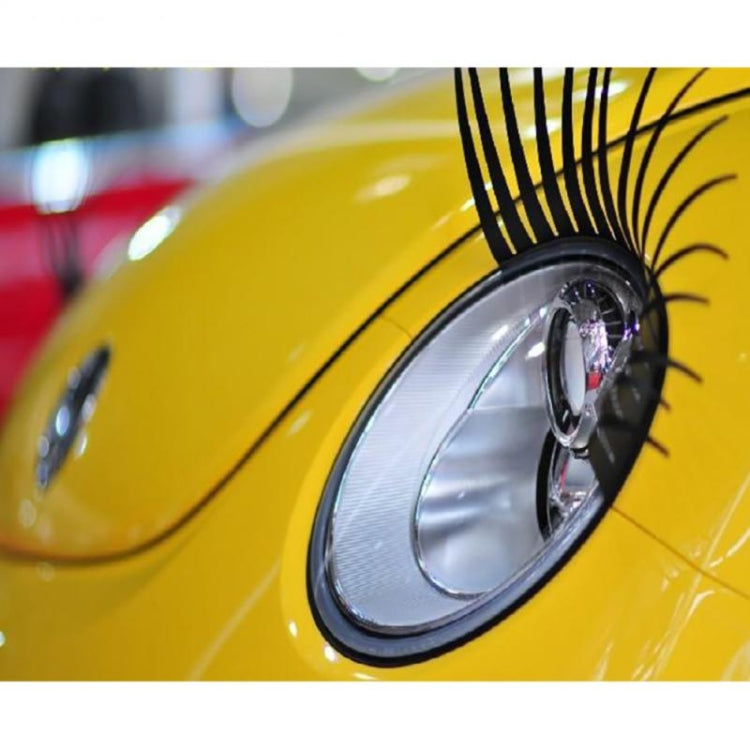 Black car eyelash decal on a vehicle fender near the headlight with lash spikes