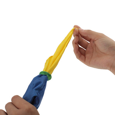 Hand holding color-changing linked silk toy; yellow and blue linked ends with green knot