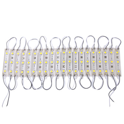 Warm white LED strip modules on a white backing with looped gray connector wires