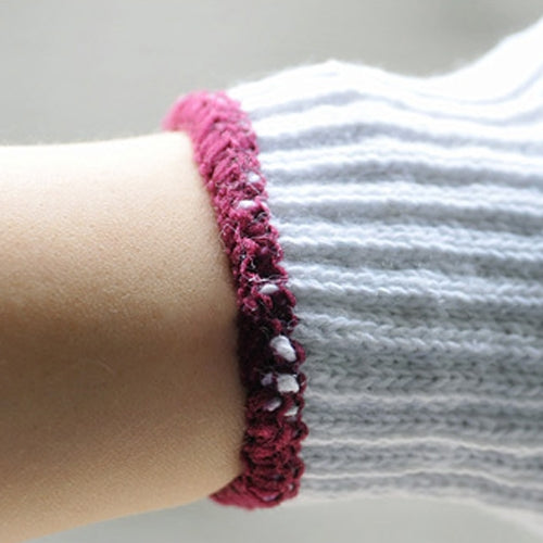 Cotton glove wrist cuff detail, white knit with magenta stitched trim