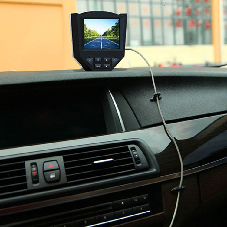 Black adhesive cable bundle clip securing a cable on car dashboard