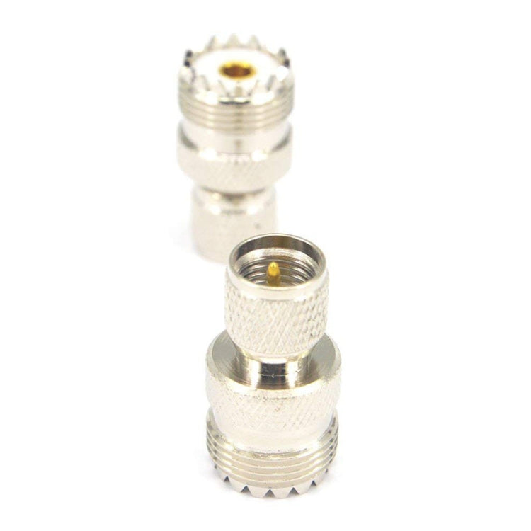 Silver UHF male-to-female coax adapter, gold center pin in threaded housing
