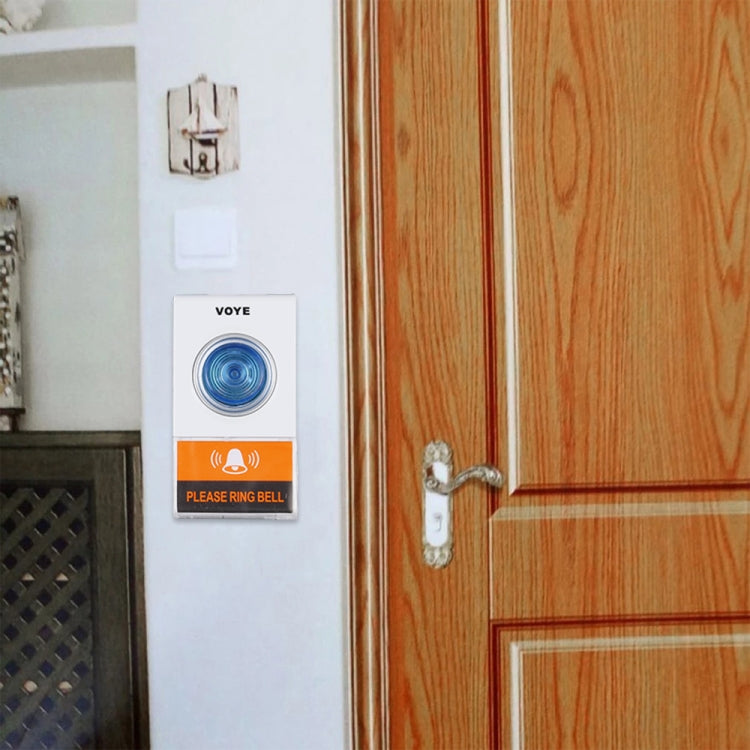 VOYE wireless doorbell remote mounted on wall beside wooden door, blue-ring button