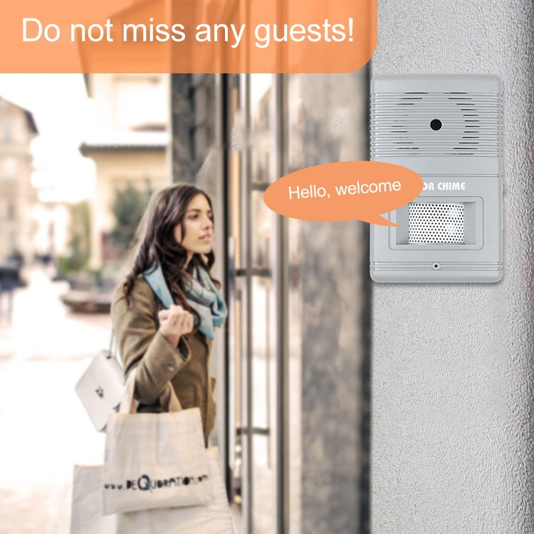 Wireless door chime mounted on wall with light gray speaker grille.