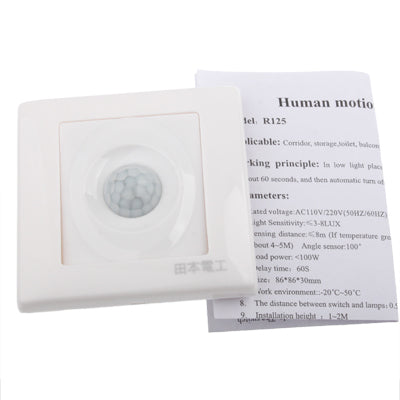 White wall motion sensor switch with circular lens, with specifications label behind