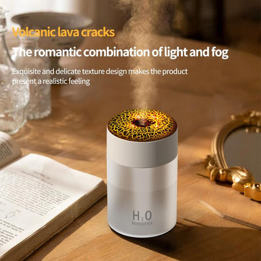 White humidifier with illuminated lava-crack dome top emitting mist