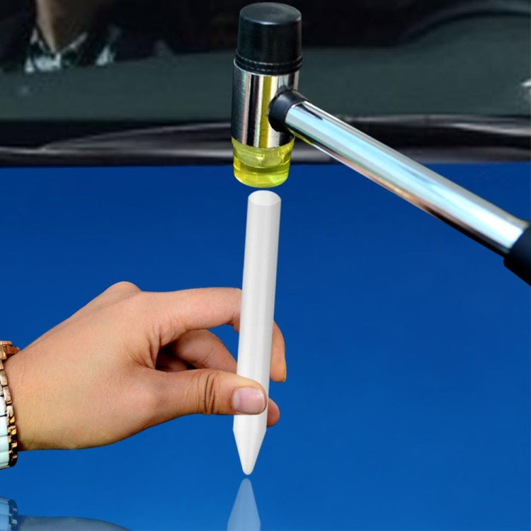 Hand holding white pointed leveling pen with metal applicator handle