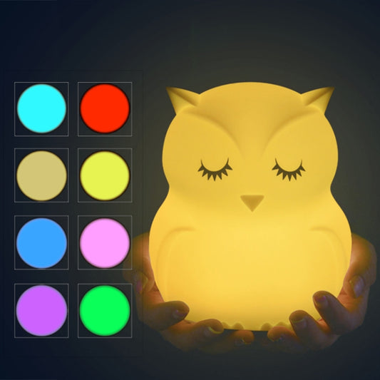 Yellow silicone owl LED night light with color option lights beside it