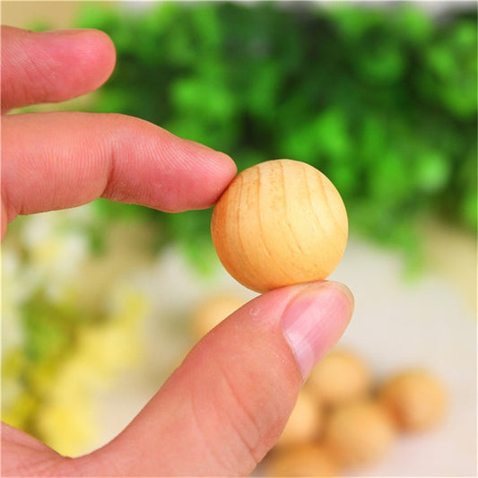 Single wooden camphor repellent ball with smooth surface and light wood swirls