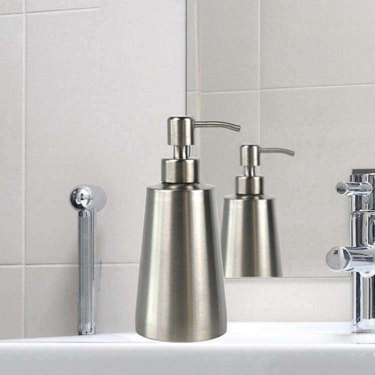 Stainless steel manual soap dispensers on bathroom sink counter