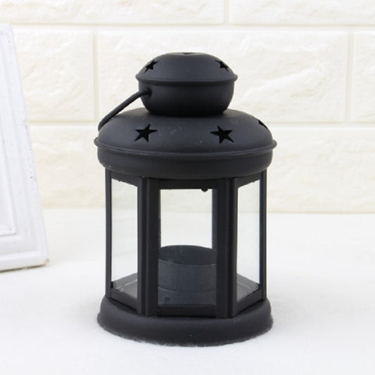 Black metal lantern candle holder with star cutouts on the top lid and base glass panels.