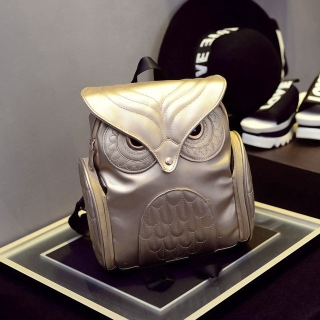 Silver and black owl-pattern mini backpacks on display with top flaps