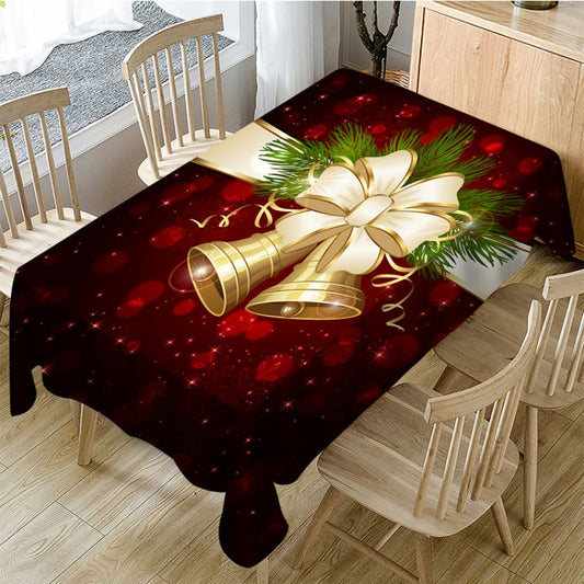 Rectangular Christmas tablecloth in dark red with gold bells and green pine bow.
