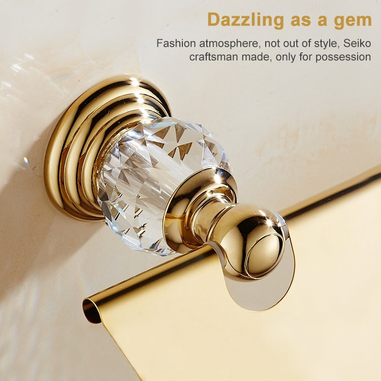 Gold toilet paper roll holder with clear crystal knob and back-mounted metal ring