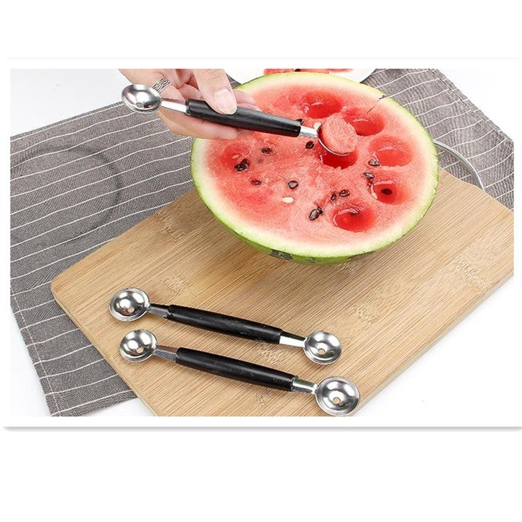 Pair of stainless fruit digging spoons with black handles and round scoops