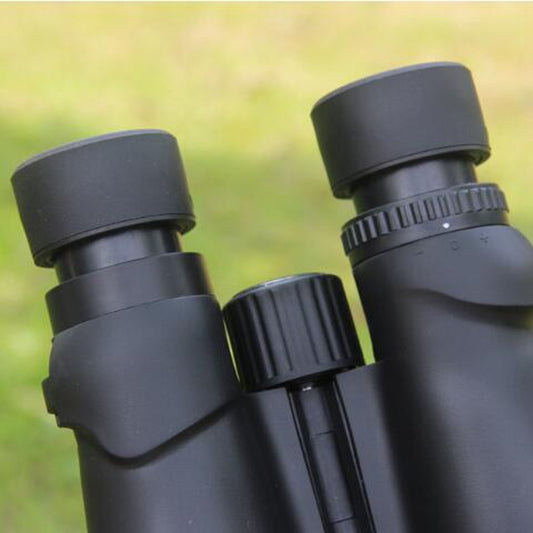 Close-up of dark gray binocular eyepieces and center focus knob