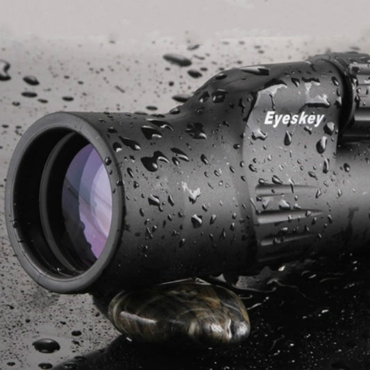 Weatherproof black monocular telescope with droplets on lens housing