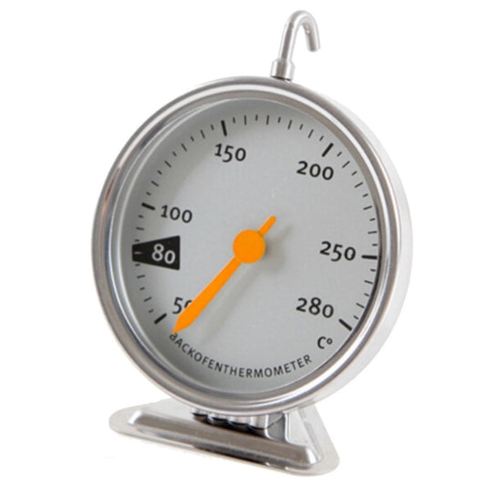 Stainless oven thermometer on tabletop stand with round dial and orange temperature pointer